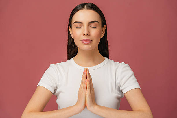 istock Peaceful Meditation Pose with Hands Joined on Pink Background 2204738480