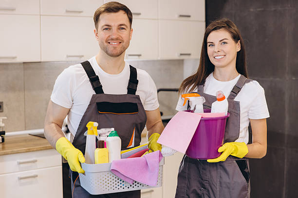 istock Cleaning company workers holding cleaning products smiling in kitchen 2204739672