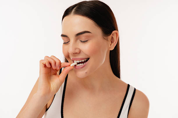 istock Young Woman Enjoying A Healthy Snack in a Bright Studio Setting 2204741013