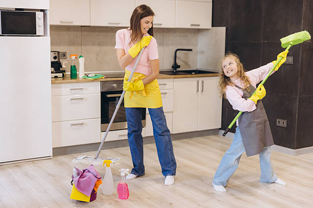 istock Mother and daughter having fun while cleaning the kitchen floor 2204741186