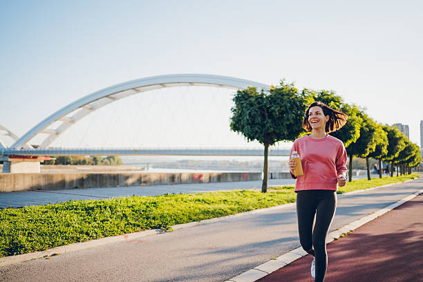 istock A young woman running with bottle 2204741457