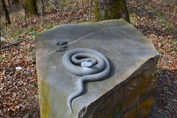 Stone sculpture of a snake king on a large stone block