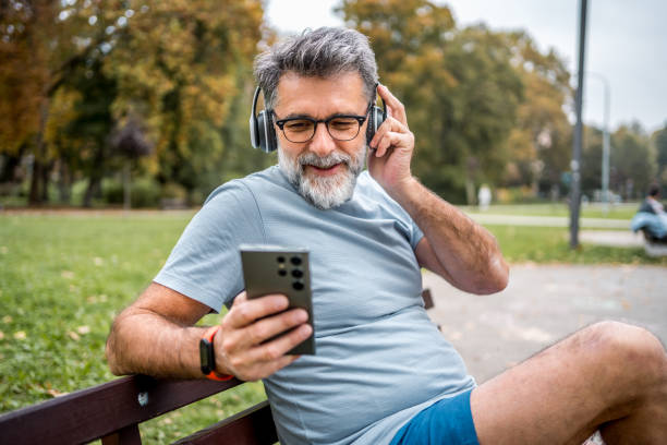 istock Mature man using phone outdoors 2204741552