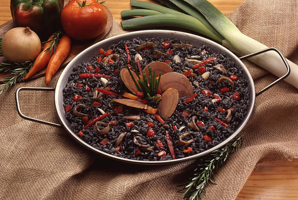 Black rice seafood paella and ingredients.