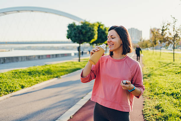istock A young woman drinks water after running 2204741740
