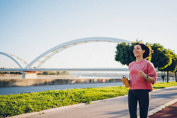 istock A young woman running with bottle 2204741906