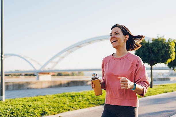istock A young woman running with bottle 2204744282