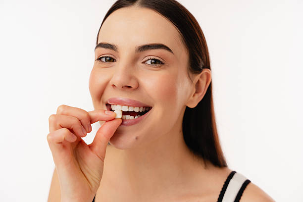 istock Smiling Person Taking a Health Supplement in a Bright Setting 2204744442