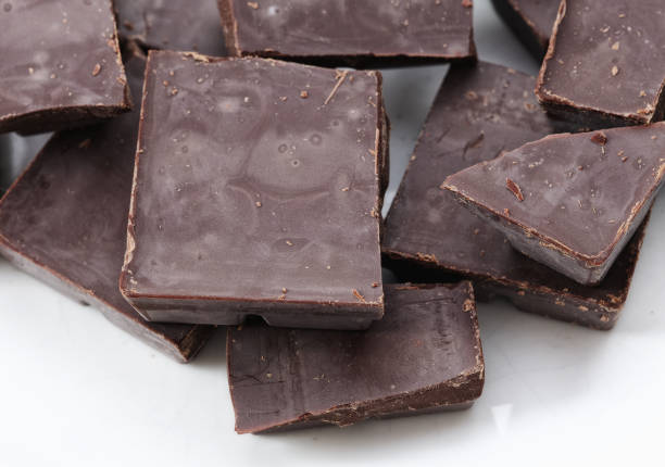 A heap of broken dark chocolate. Close up.