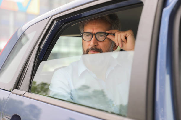 istock Professional Man Relaxing in the Back Seat 2204745407
