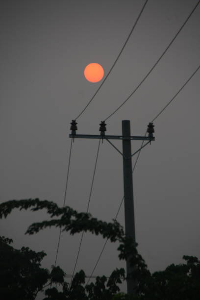 istock Sunrise Silhouette Behind the Power Lines 2204745500