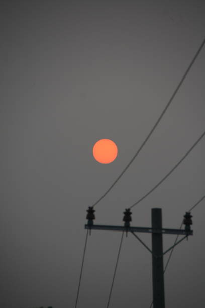 istock Sunrise Silhouette Behind the Power Lines 2204745508