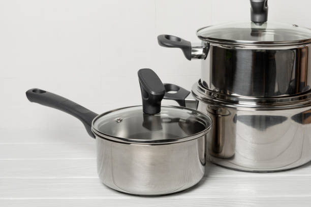 istock Stainless steel saucepan on light kitchen background. Modern saucepan. Kitchenware. Cooking pot. Cooking concept. Mockup. Space for text. Copy space. 2204747130