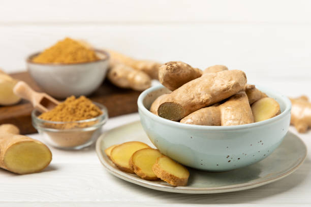 istock Fresh ginger on wooden background. Dry ginger. Sliced ​​ginger with honey and lemon. Ginger root. Traditional alternative medicine, healing tea for immunity. Seasoning and spices concept. Copy space. 2204747615