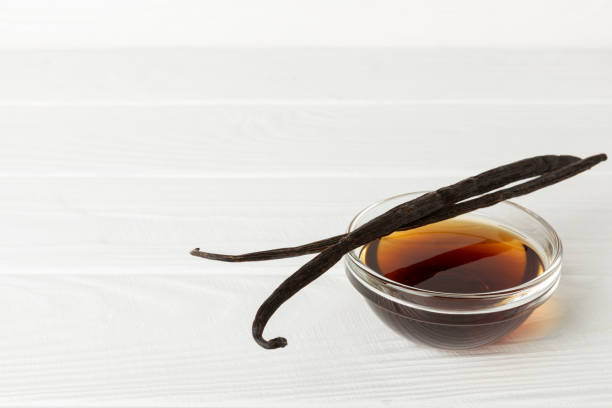 istock Vanilla extract in glassware on a wooden table. Vanilla extract for baking and desserts. Aromatic Homemade Vanilla Extract. Close -up. Place for the text. Copy space. 2204748396