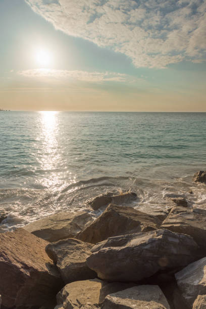 istock Cliff on the sea at sunset and slightly cloudy sky 2204748737