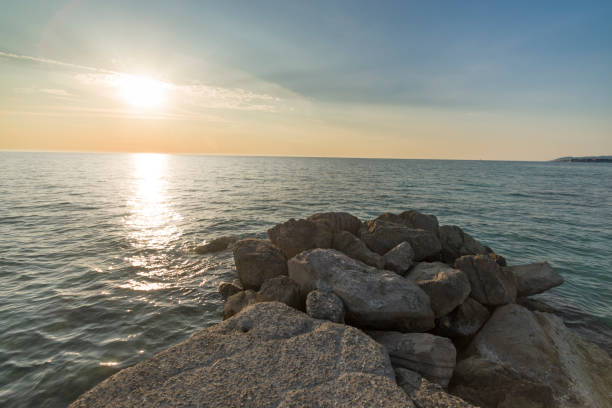 istock Cliff on the sea at sunset and slightly cloudy sky 2204748742
