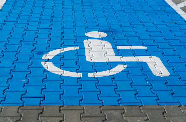 istock A blue parking area is clearly designated for individuals with disabilities, featuring a white accessibility symbol on the ground surface 2204748918