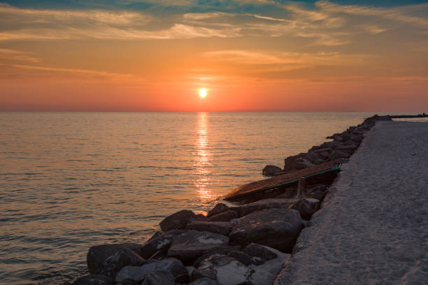 istock Cliff on the sea at sunset and slightly cloudy sky 2204749244