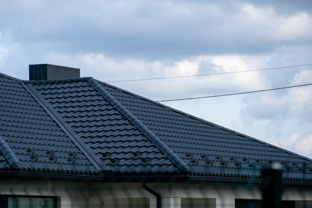 istock A contemporary house features a sleek rooftop design, surrounded by dramatic clouds. Power lines stretch across the horizon as sunlight hints through 2204749325