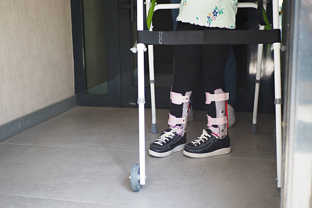 istock child with walking frame and knee orthosis outdoor 2204749377