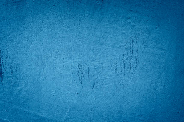 istock blue background of blue plaster with scuffs and unevenness 2204749454