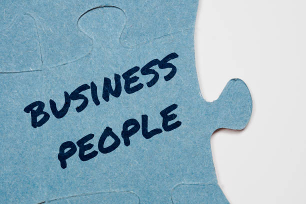 istock Business People text on puzzle pieces 2204749814