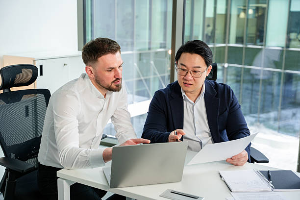 istock Professional Business Discussion Between Two Colleagues in a Modern Office 2204750161
