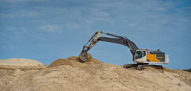 istock Coastline construction activity involves heavy machinery moving sand on a sunny day for erosion prevention at a coastal site 2204750279