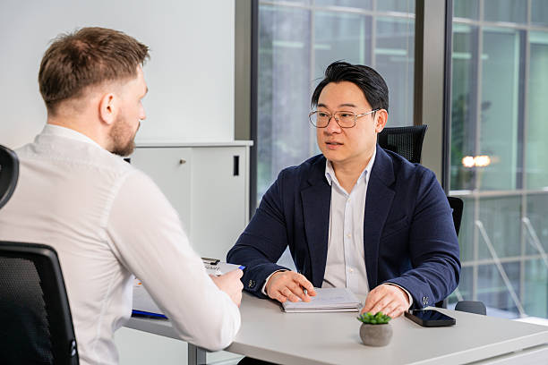 istock Professional Business Meeting In Modern Office Setting Near Large Windows 2204750905