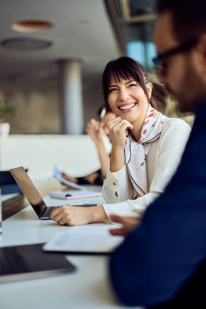 istock Businesswoman Smiling During a Collaborative Meeting in a Modern Office Setting 2204752333