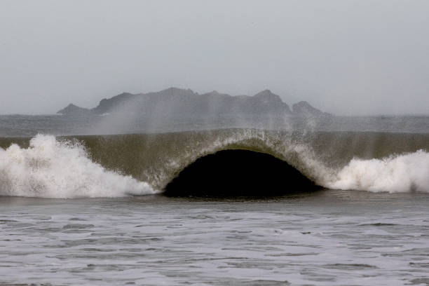 Rough weather and off shore winds create dramatic waves with lots of mist and white spray.