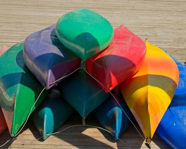istock Pyramid stack of colorful kayaks on wood deck 2204754944