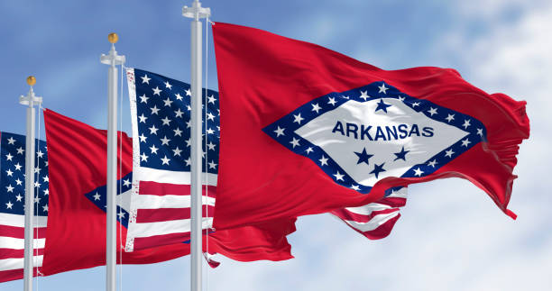 istock Arkansas state flags waving with the American flags on a clear day 2204755326