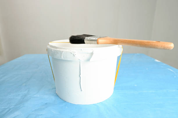 Using a rubber band across its center causes the paint will drip across the rubber band and back into the can to minimize the mess