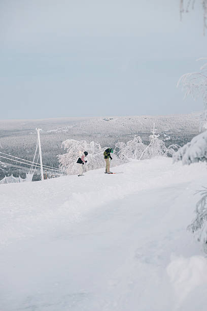 istock Tourists skiing down a snowy slope in winter 2204756400