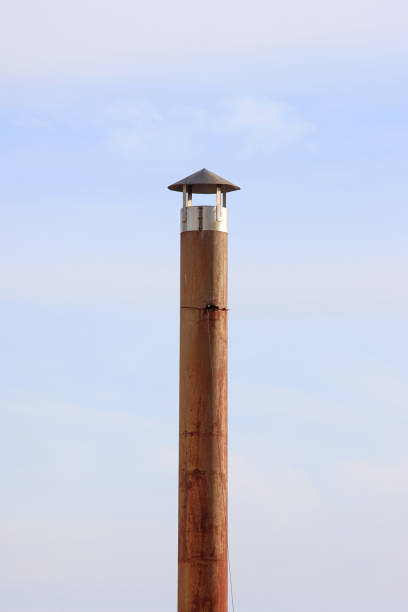 Antique industrial iron fireplace under the blue sky