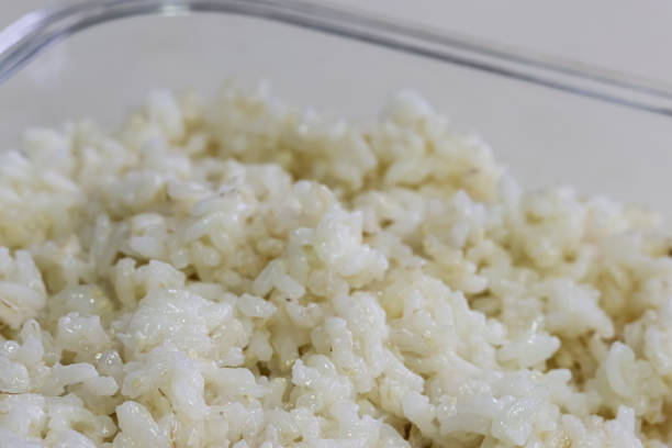 Close-up.  A glass bowl with cooked white rice.