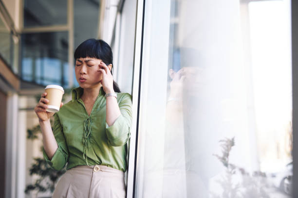 istock Stressed Asian Businesswoman having a Headache at Work 2204758457