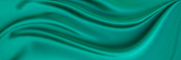 istock Black green satin dark fabric texture luxurious shiny that is abstract silk cloth background with patterns soft waves blur beautiful. 2204759708