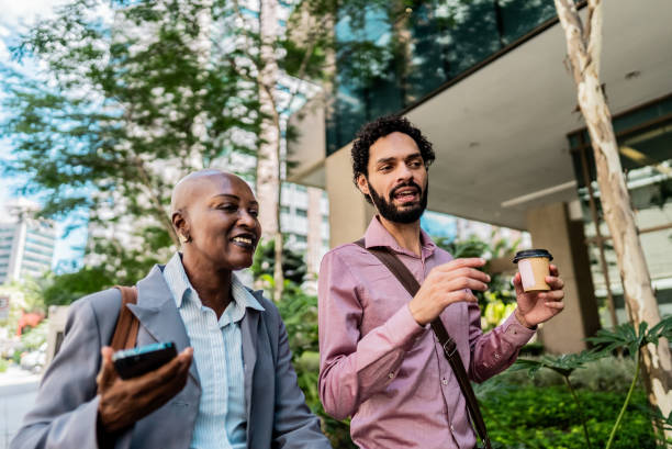 istock Coworkers talking while walking in the street 2204759990