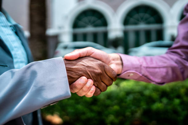 Senior man and young man holding hands