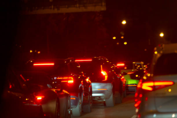 istock A slightly blurred image shows cars driving down a street at night 2204762583
