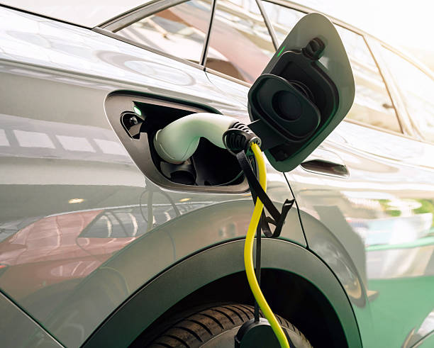 istock Diagonal view of EV charging plug inserted into electric car 2204763541