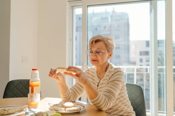 istock Senior woman is having a healthy breakfast 2204763614
