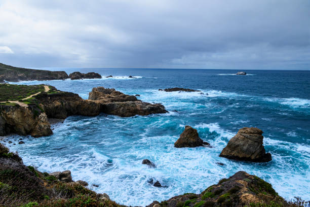 High angle view of rocky shore and crashing ocean waves along the Big Sur coast.Taken at from California Highway One, Big Sur, California, USA