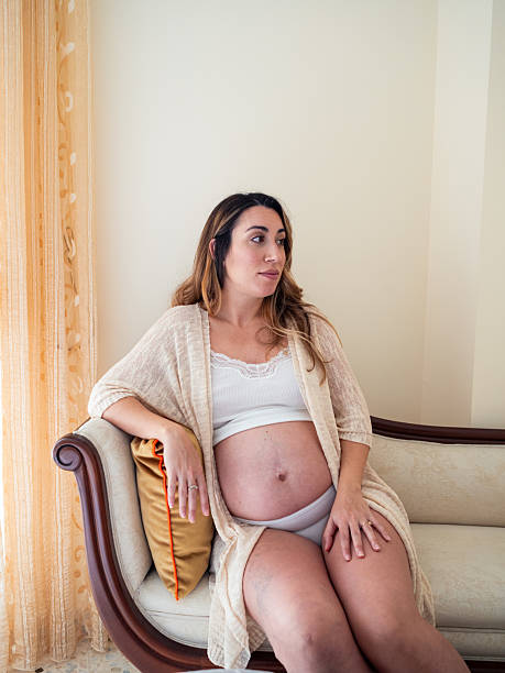 istock Pregnant woman relaxing at home in comfy setting 2204766262