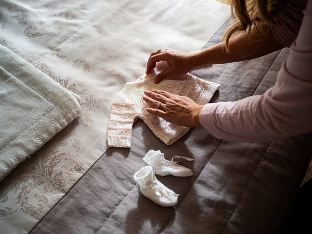 istock Preparing a newborn outfit on a soft bed in a cozy room 2204767161