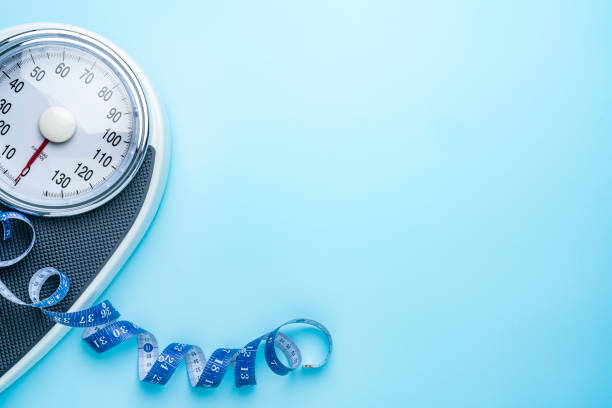 istock Weight scale and measuring tape on blue background. Flat lay with copy space 2204767191