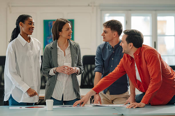 istock Young professionals collaborating on charts in a modern office 2204767429